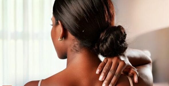 Firefly women showing her dark skin back neck area using one hand in room 64